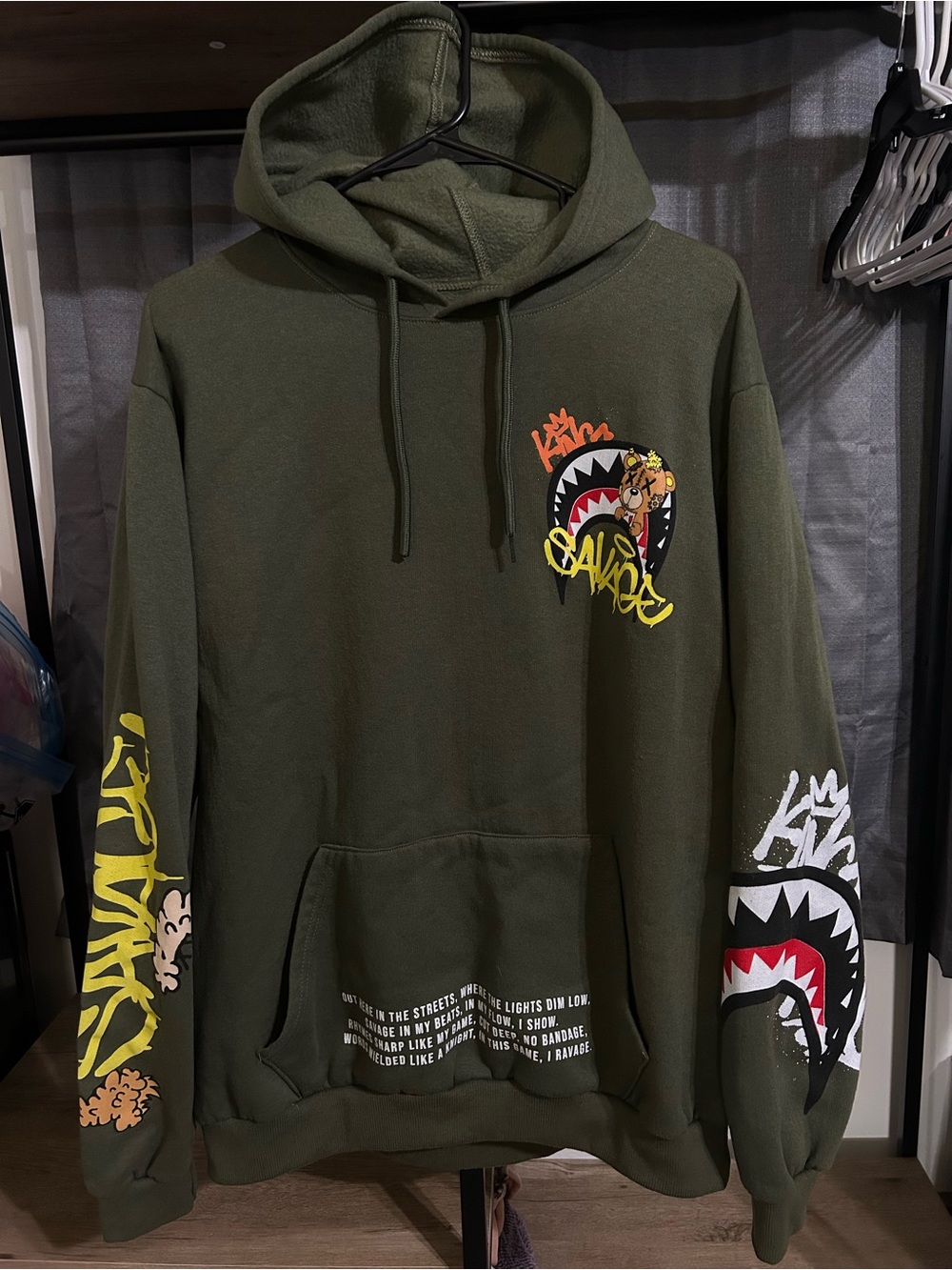 Olive Green Graphic Pullover Hoodie with Bold Sleeve Art